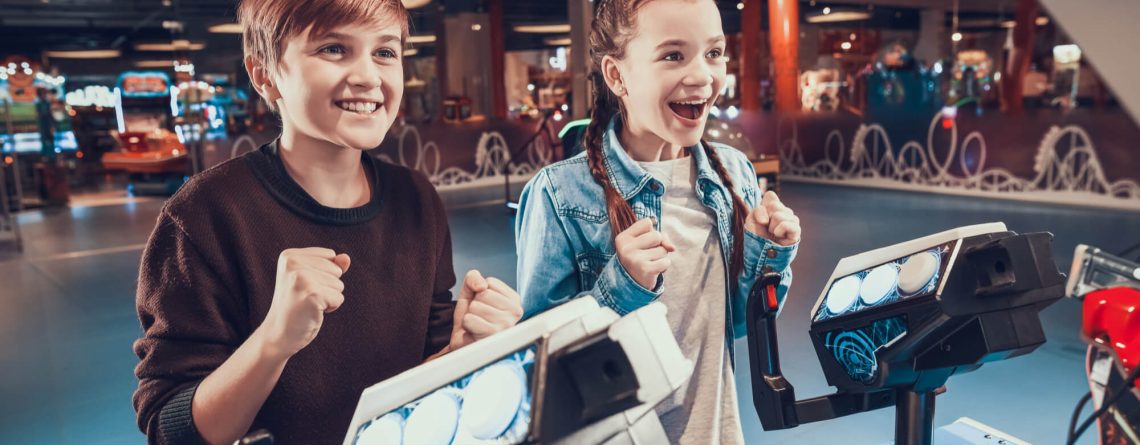 Boy and girl playing arcade game